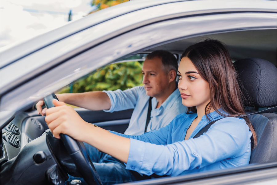 teen learning to drive with father in car